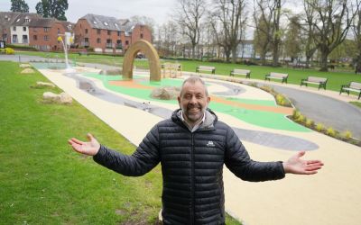 A council worker in front of a new water play area in Wychavon